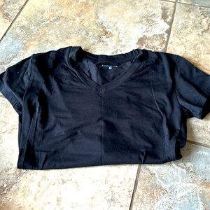 Black T-shirt size medium fits closer to small
